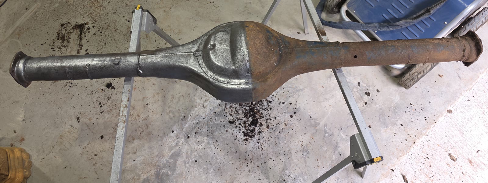 Axle housing with a cleaned left side and a rusty right side