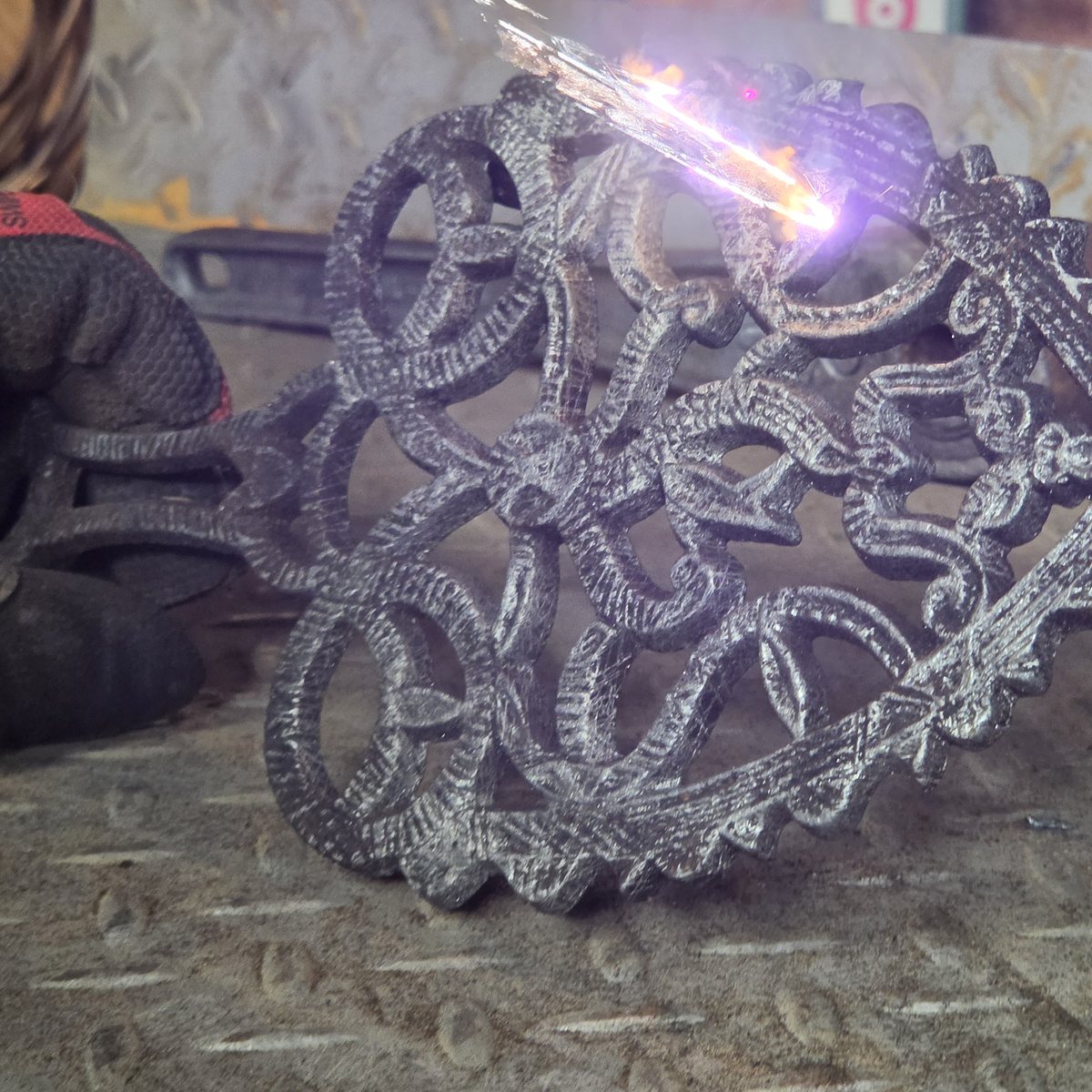 Cast iron trivet being laser cleaned